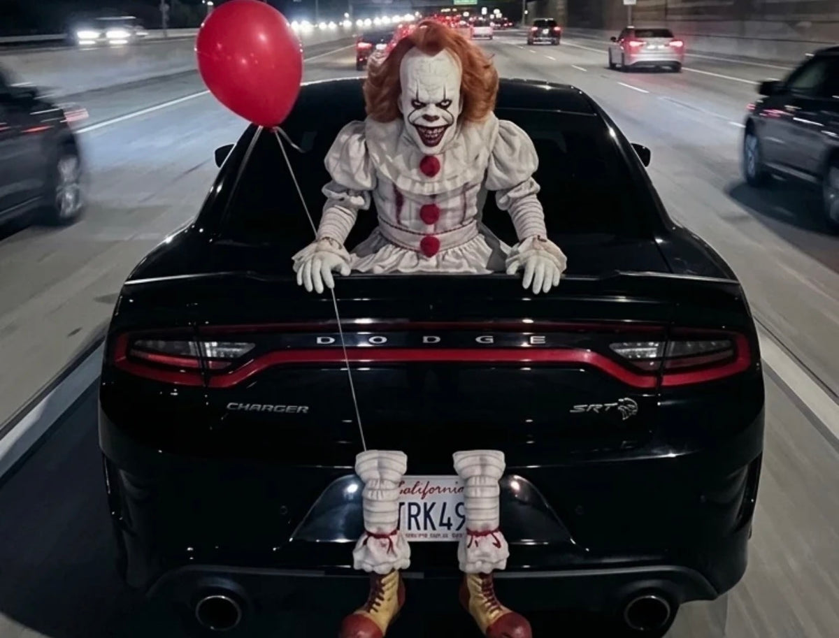 Horror clown trunk prop on car