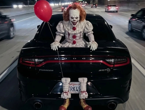 Horror clown trunk prop on car